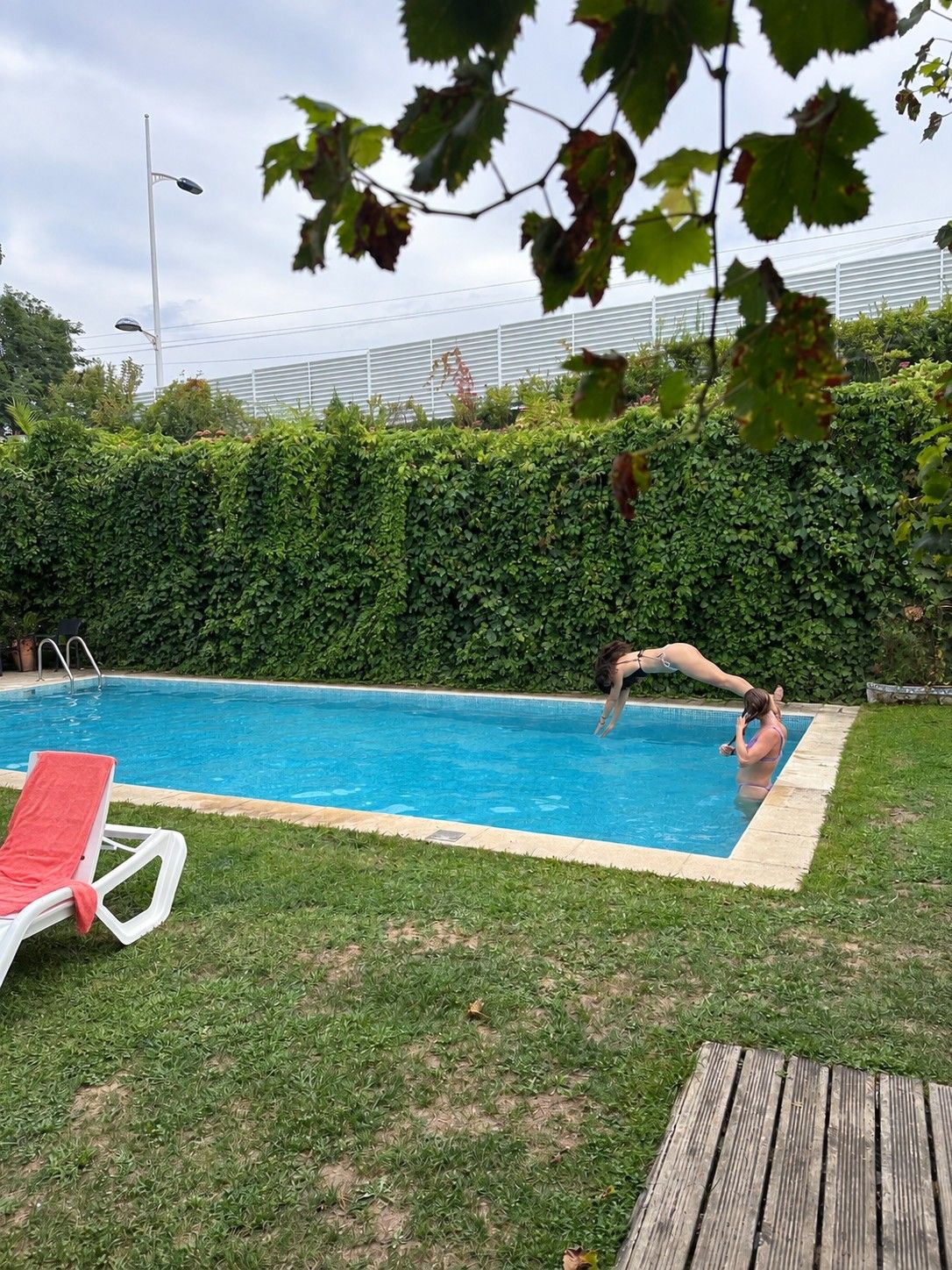 La piscina de Casa Azul, enmarcada por el jardín y el seto.